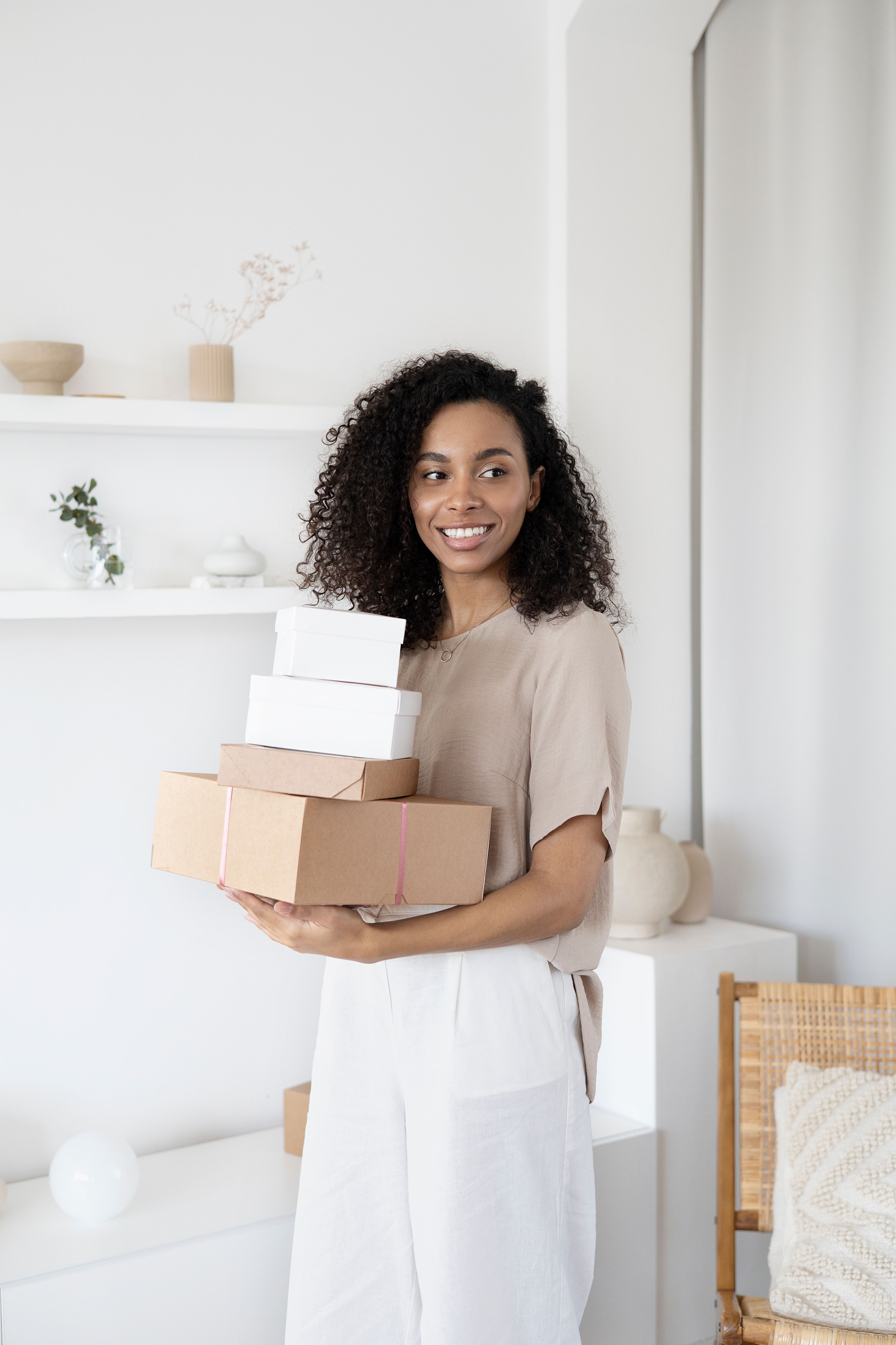Smiling woman holding prepared packages for dispatch